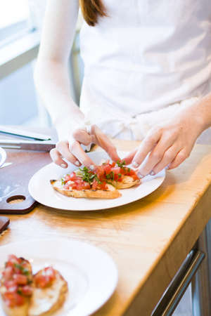 Kinds in cooking class making bruschetta.の写真素材