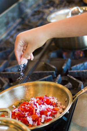Kids learning how to make fresh fettucini with chicken, red peppers, and basil pesto.の写真素材