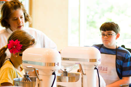 Kinds in cooking class learning how to cook and bake.のeditorial素材