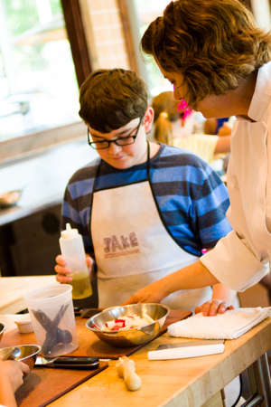 Kinds in cooking class learning how to cook and bake.のeditorial素材