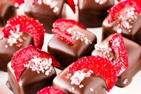 Strawberry daiquiri truffles on a white background.