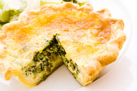 Individual spinach quiche served with salad.の写真素材