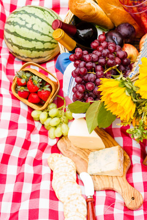Summer picnic with a basket of food in the park.