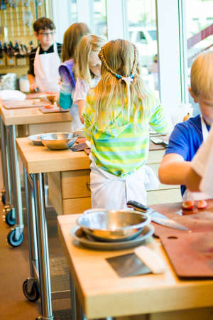 Kids learning how to cook in a cooking class.の写真素材