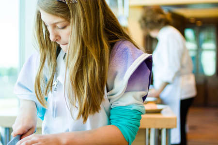 Kids learning how to cook in a cooking class.の写真素材
