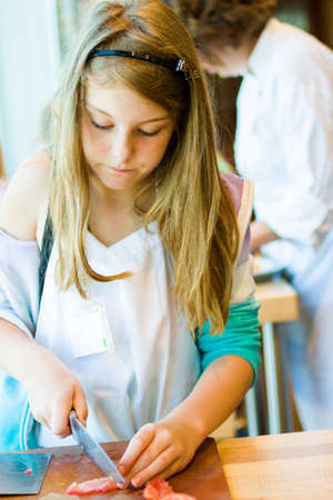 Kids learning how to cook in a cooking class.の写真素材