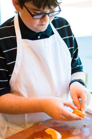 Kids learning how to cook in a cooking class.の写真素材
