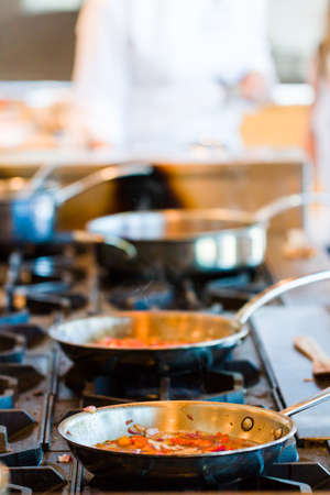 Kids learning how to cook in a cooking class.の写真素材