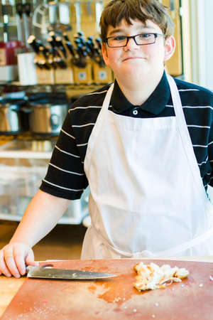 Kids learning how to cook in a cooking class.の写真素材