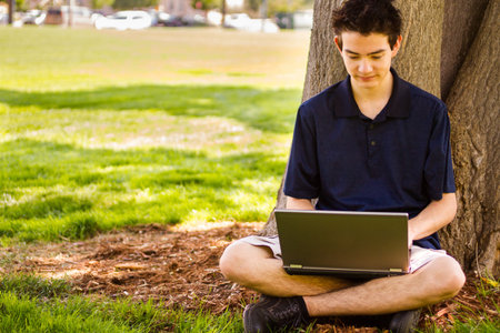 College student with laptop on campus.