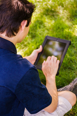 College student with computer tablet on campus.