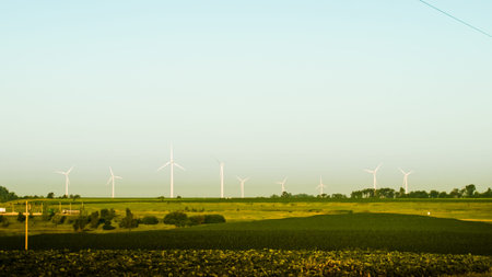 Wind turbines farm at sunrise in Iowa.