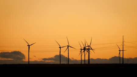 Wind turbines farm at sunset in Limon, Colorado.の写真素材