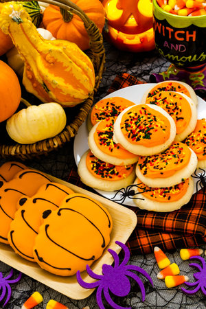 Sugar cookies with orange icing and spkinkles.
