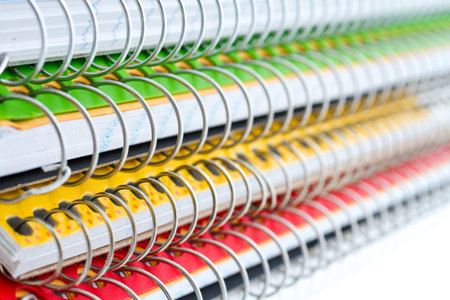 Multicolored spiral notebooks on a white background.の写真素材