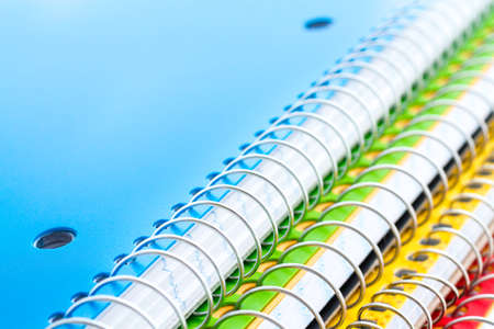 Multicolored spiral notebooks on a white background.の写真素材