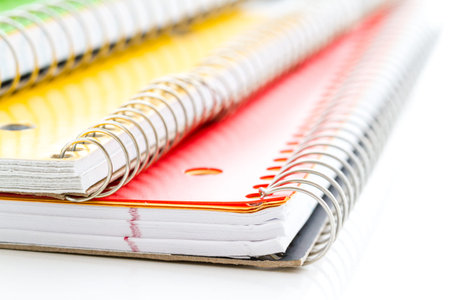 Multicolored spiral notebooks on a white background.の写真素材