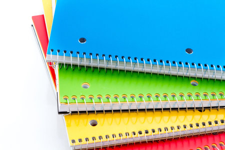 Multicolored spiral notebooks on a white background.の写真素材