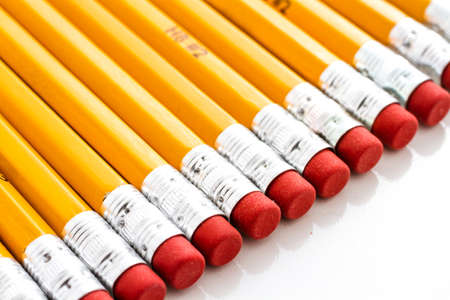 Classic yellow pencils with red eraser on a white background.の写真素材