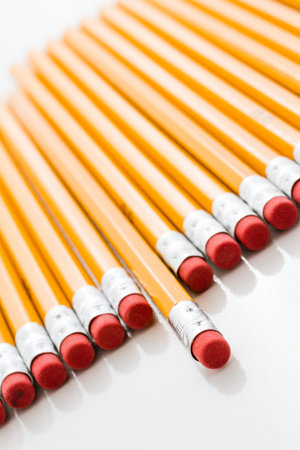 Classic yellow pencils with red eraser on a white background.