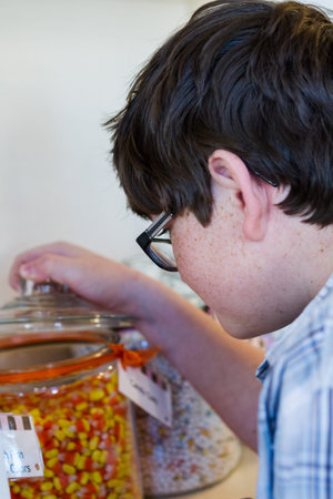 Teenager shopping at the boutique candy store.