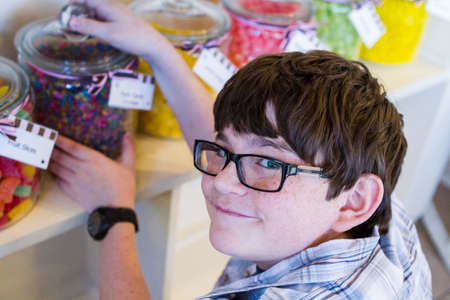 Teenager shopping at the boutique candy store.の写真素材