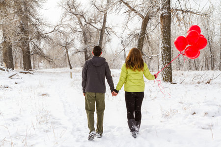 Teenager boy with his girlfriend walking in the park.の写真素材