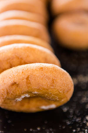 Row of fresh donuts from the local bakery shop.の写真素材