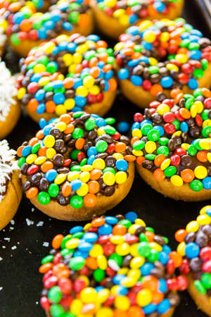 Fresh donuts with different toppings from the local bakery shop.のeditorial素材