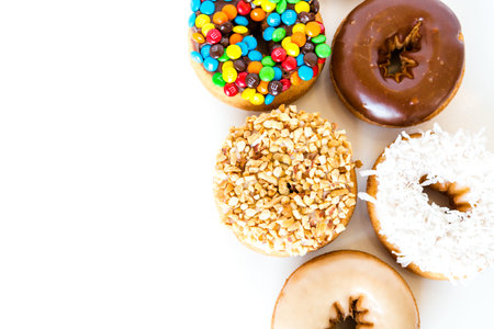 Variery of fresh donuts on a white background.のeditorial素材