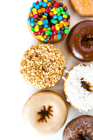 Variery of fresh donuts on a white background.のeditorial素材