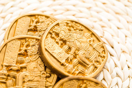 Gourmet Maya glyphs in dark chocolate covered with gold dusting.の写真素材