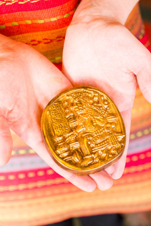 Gourmet Maya glyphs in dark chocolate covered with gold dusting.の写真素材