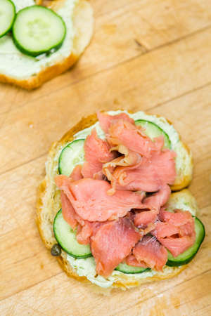 Preparing lox delight sandwich with fresh croissant.の写真素材