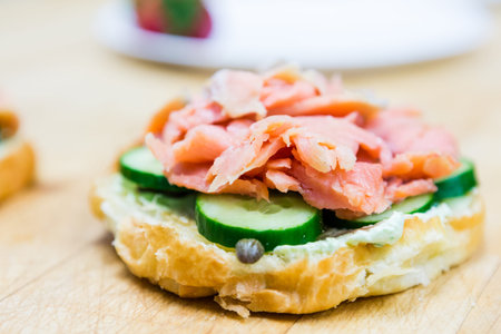 Preparing lox delight sandwich with fresh croissant.の写真素材