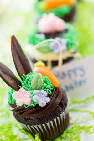 Easter chocolate cupcakes decorated with piggy and bunny ears.