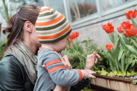 Young mother playing with her son in early Spring.