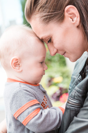 Young mother playing with her son in early Spring.