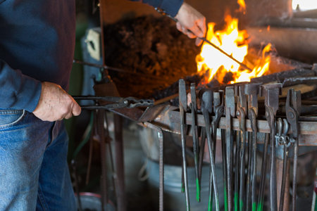 A blacksmith working at an old iron forge.
