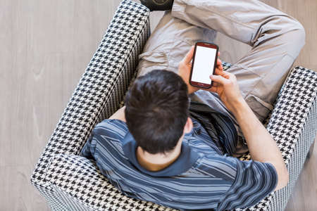 Teenage boy playing with his computer gadgets at leisure time.の写真素材