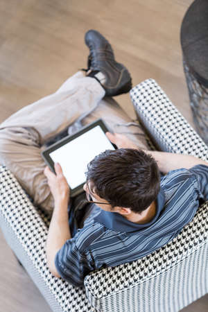 Teenage boy playing with his computer gadgets at leisure time.の写真素材