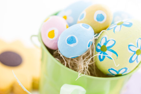 Green basket with hand painted Easter eggs.