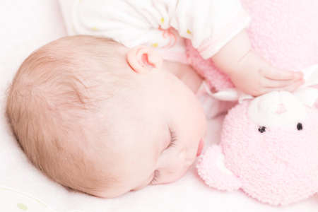 Cute baby girl sleeping in her crib.の写真素材