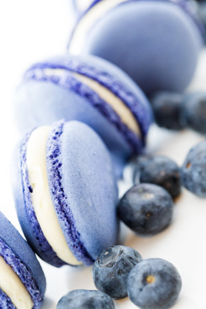Gourmet small colorful French macarons with blueberry flavor.の写真素材