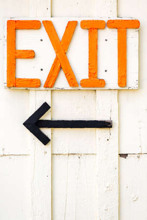 Painted exit sign on white siding.の写真素材