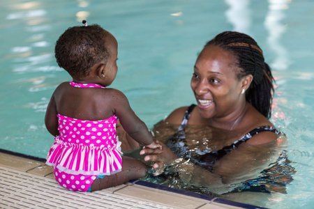 Infant swimming lessons in indoor pool.