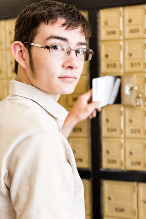 College student checking mail at mailboxed.の写真素材