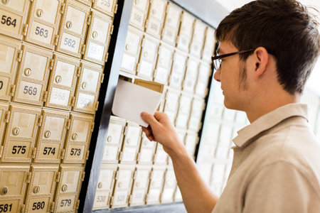 College student checking mail at mailboxed.の写真素材