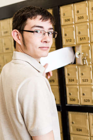 College student checking mail at mailboxed.の写真素材