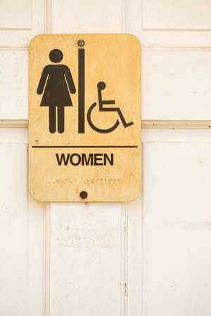 Sign on a white door to womens restrooms.の写真素材